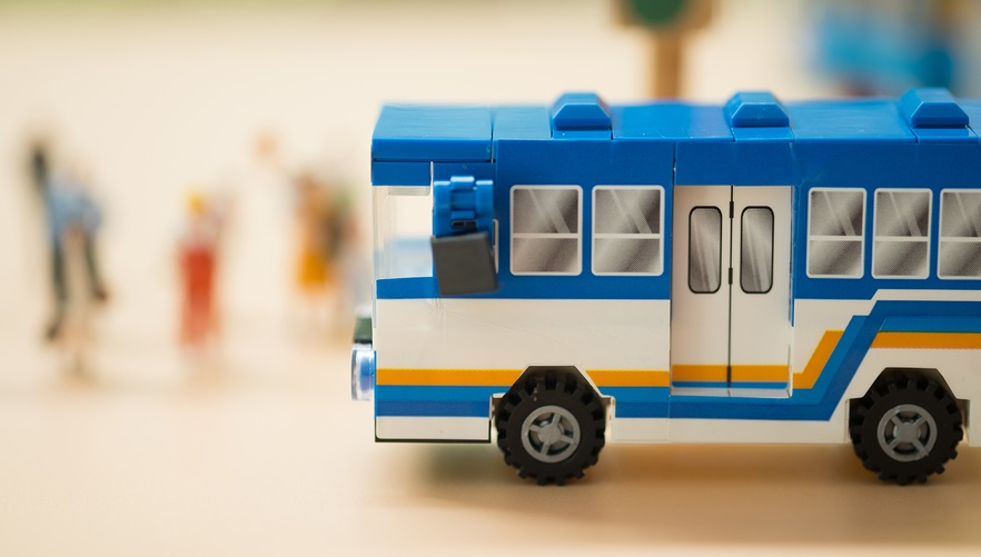 Bigstock Miniature Toy Bus People Trav 323887771 5e1e9ba1a7e53