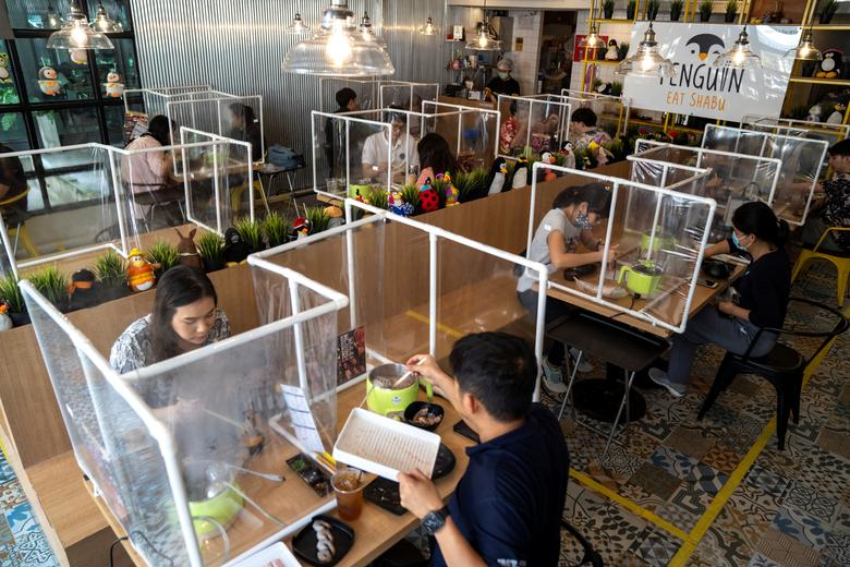 A restaurant in Bangkok, Thailand employs the use of barriers to stop infection. Credit: Reuters
