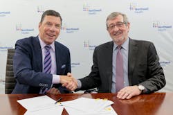 John M. Murphy, M.D., president and CEO of Nuvance Health (left), shakes hands with Northwell President and CEO Michael Dowling, at a signing ceremony.