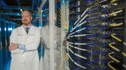 Alexander Pearson, MD, PhD, an oncologist and computational scientist at the University of Chicago, at the Research Computing Center's Midway data center. Pearson runs quantum-classical hybrid algorithms in search of cancer biomarkers across genomic, imaging, and pathology data.