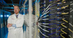 Alexander Pearson, MD, PhD, an oncologist and computational scientist at the University of Chicago, at the Research Computing Center's Midway data center. Pearson runs quantum-classical hybrid algorithms in search of cancer biomarkers across genomic, imaging, and pathology data.